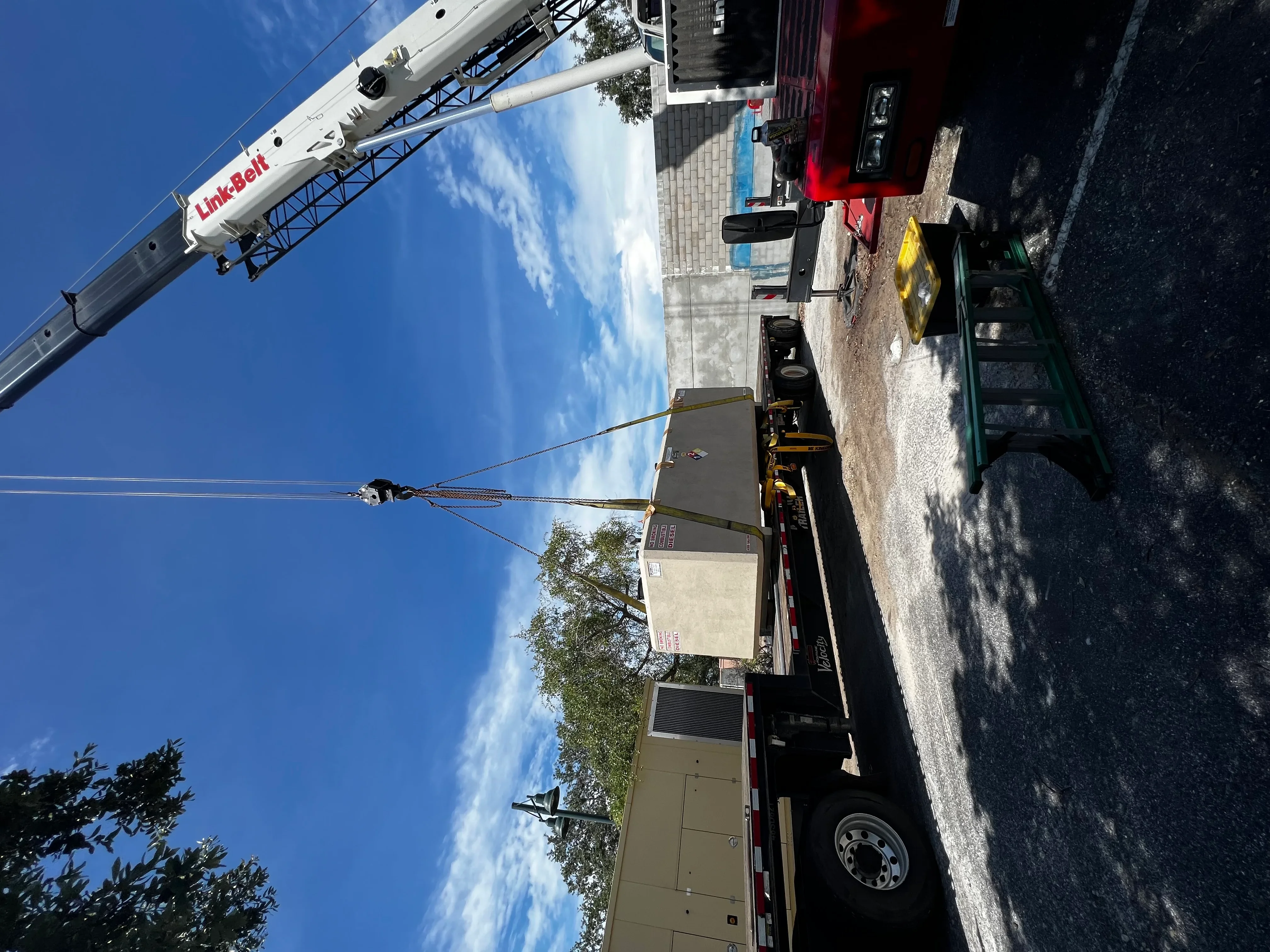 Link-Belt crane lifting generator unit to commercial rooftop installation site