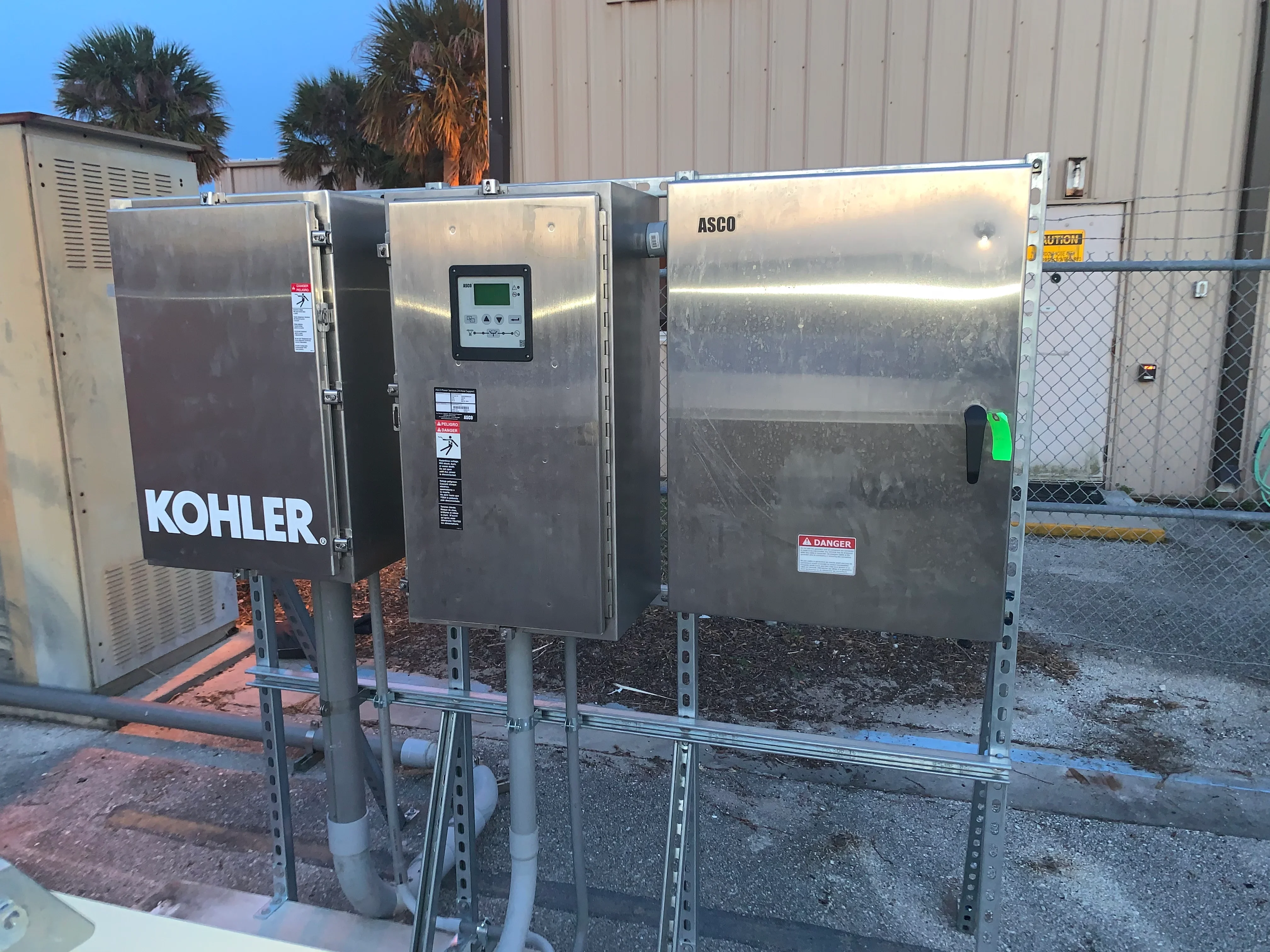 Kohler and ASCO generators on steel frame mounts with control panels and electrical connections