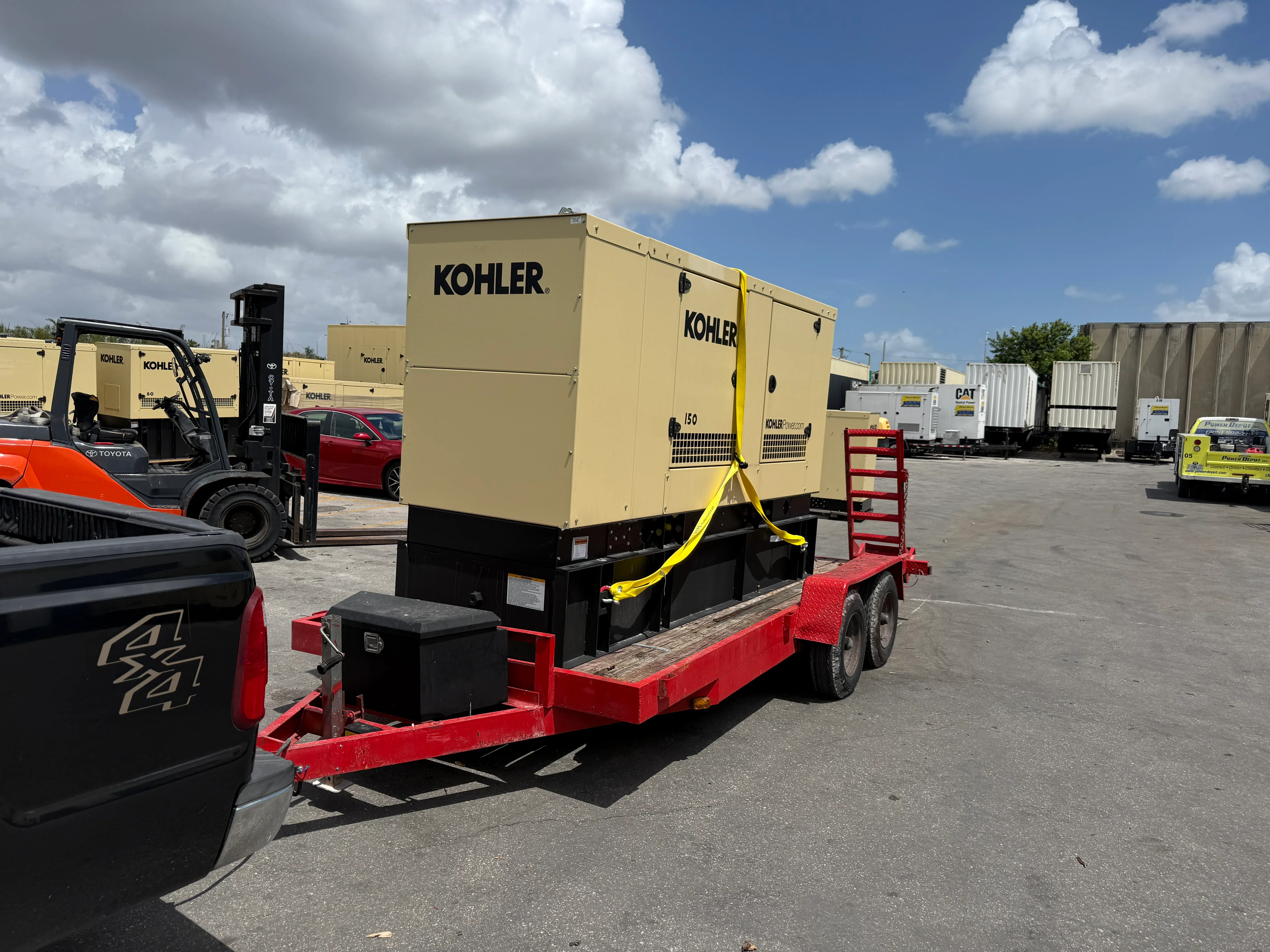 Kohler diesel generator on red trailer with yellow tie-downs and fuel tank